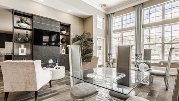 A modern living room with a glass table and chairs
